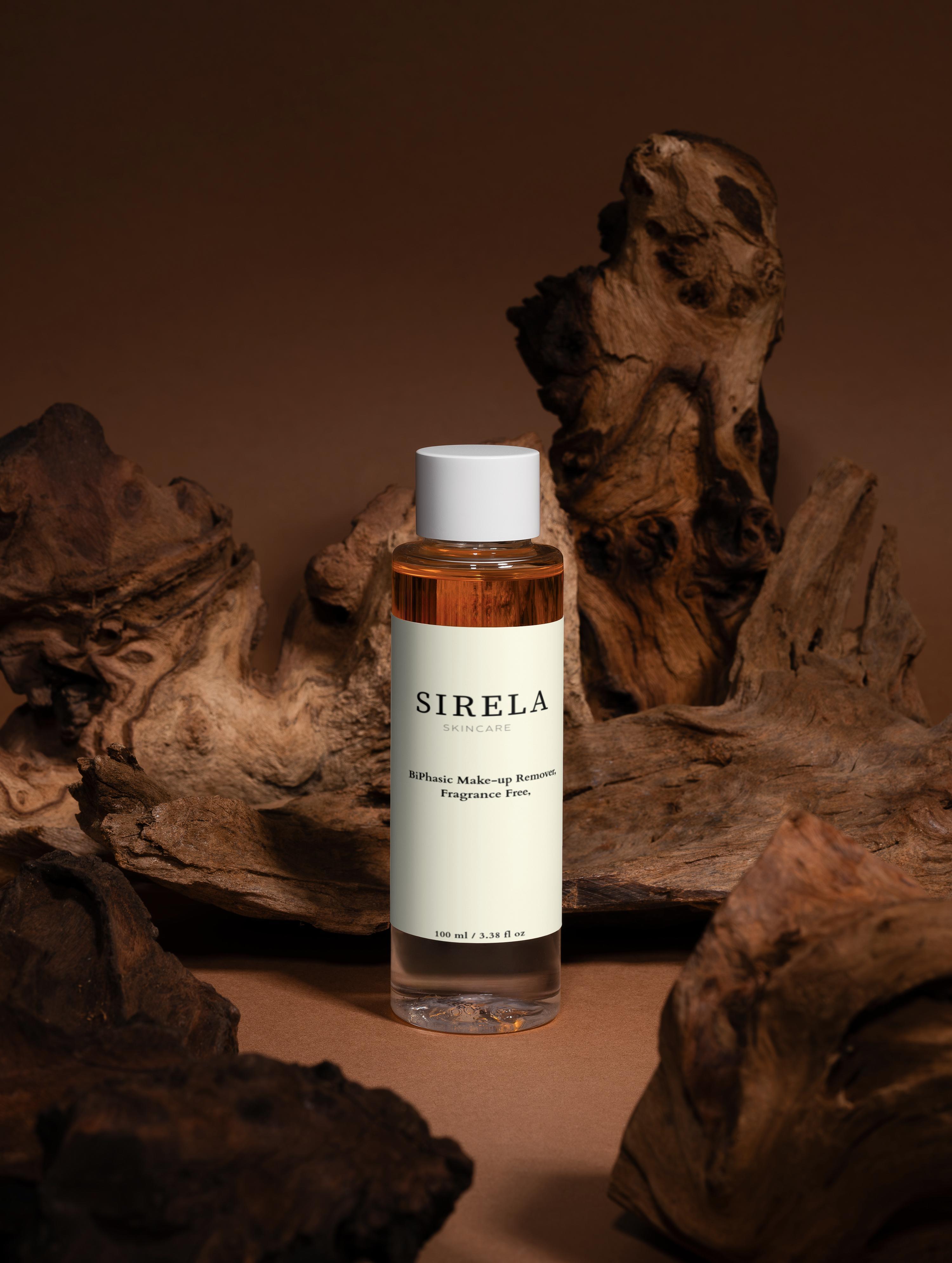 Sirela skincare Biphasic makeup remover bottle on a wooden background