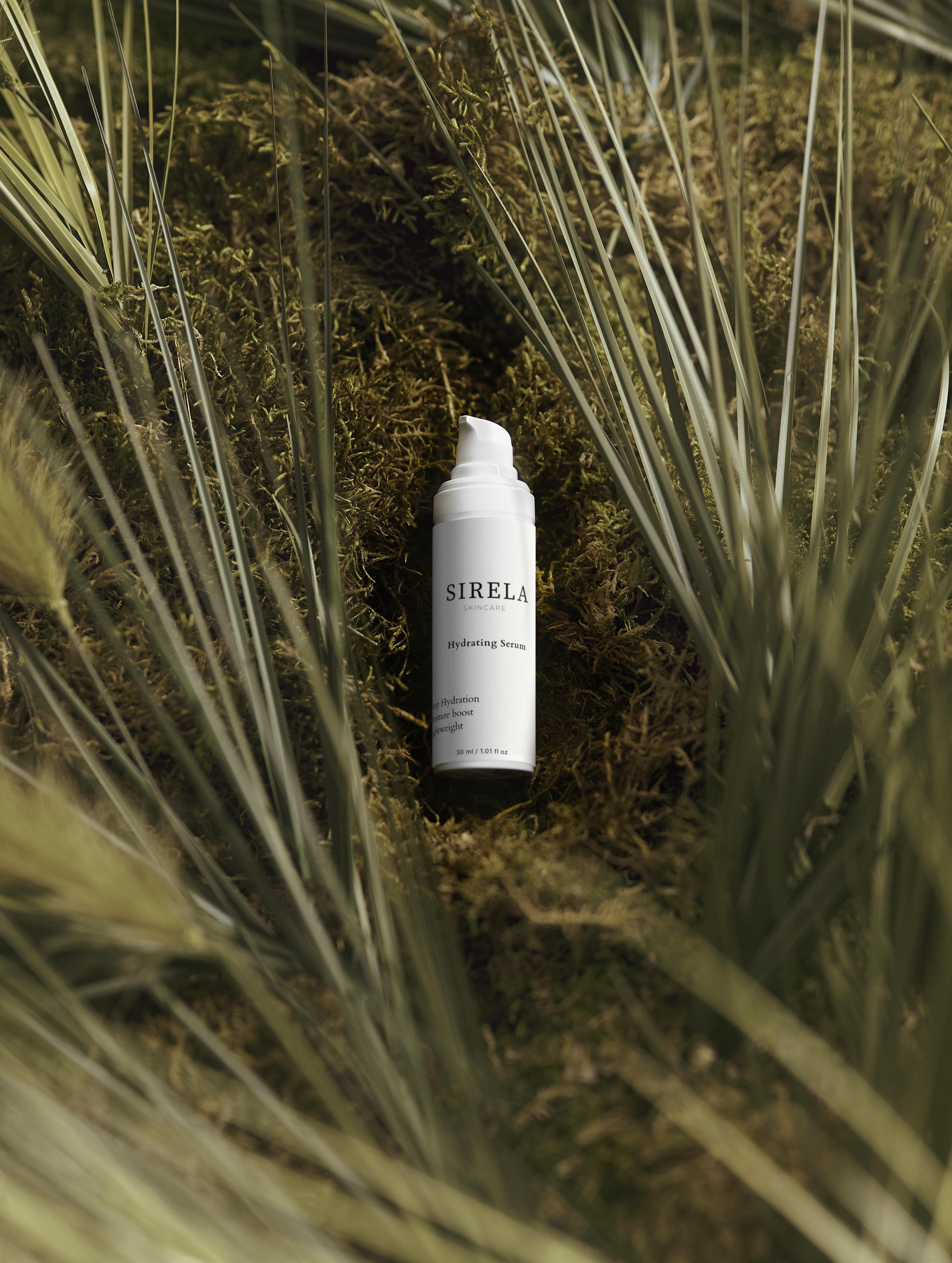 Sirella skincare bottle on a natural background with grass and moss