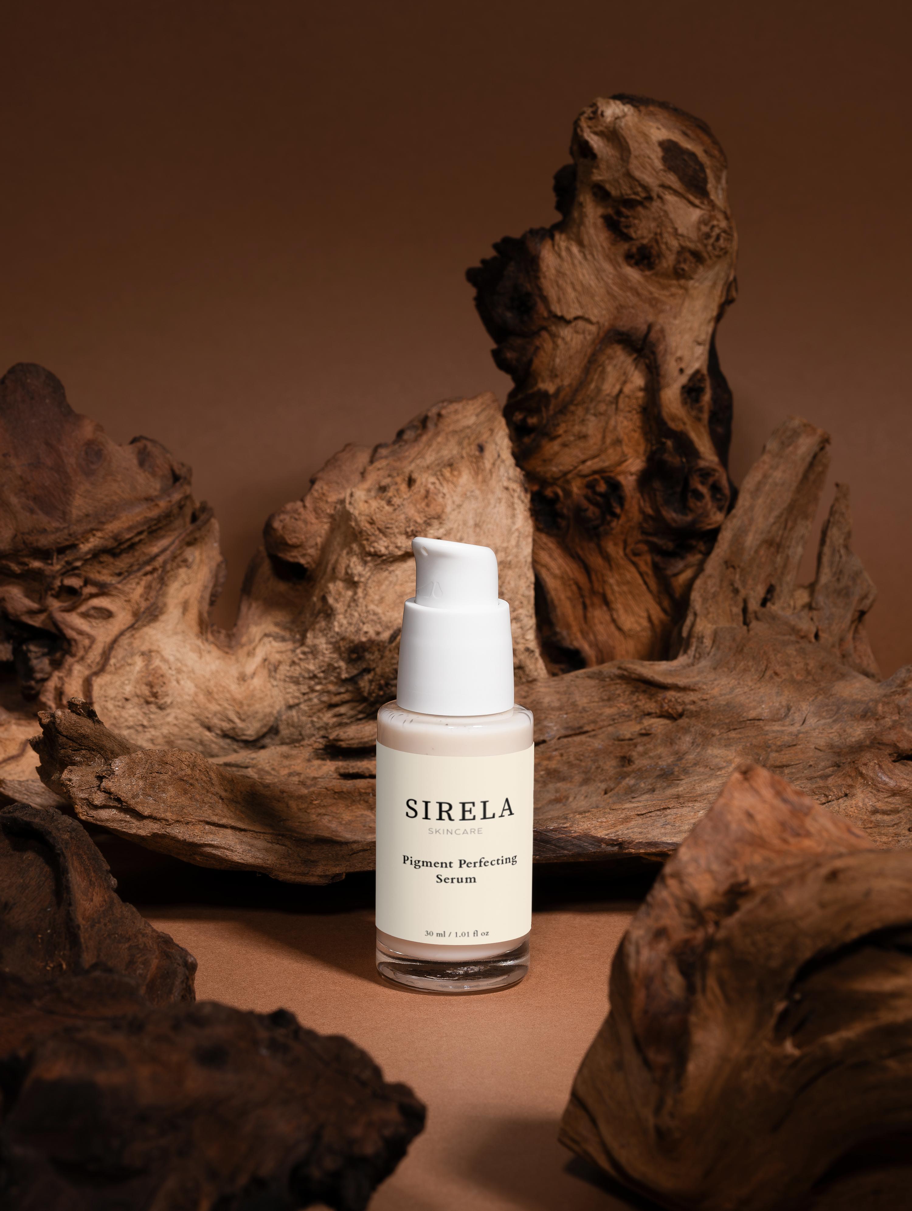 SIRELA serum bottle on a brown background with natural wood elements