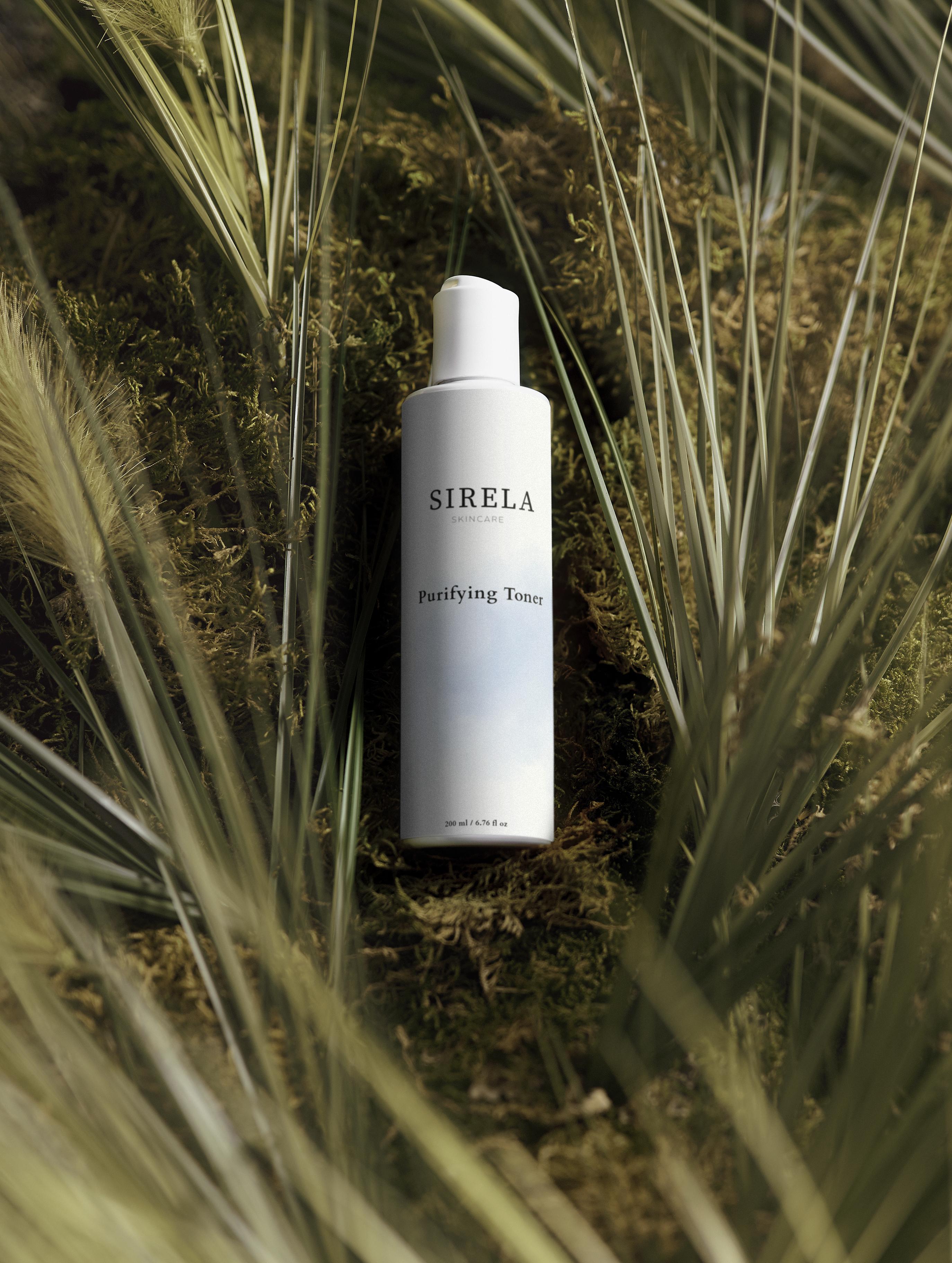 SIRELA toner bottle in a natural setting with grass and moss